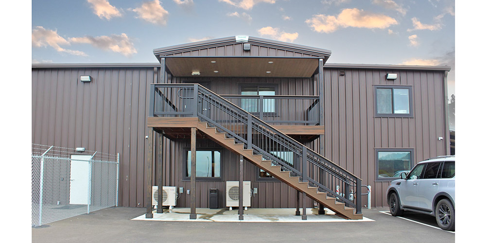 At-eave canopy above external stairs to metal building